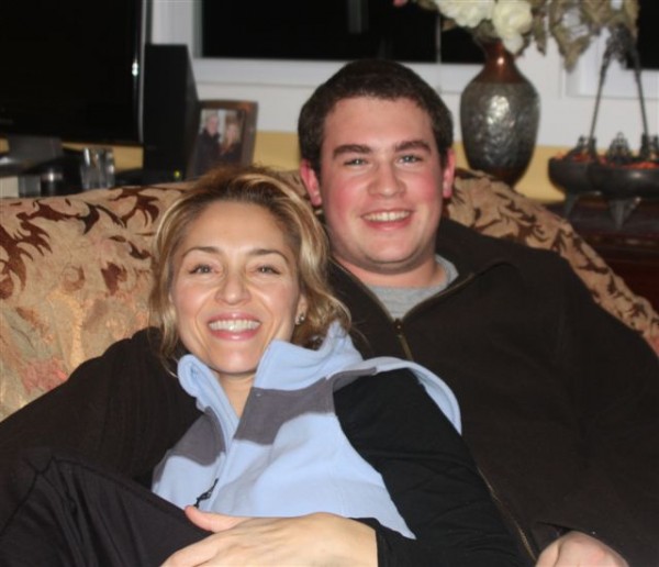 Mom with teen son smiling on couch