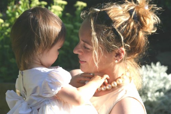 Daughter plays with mother's pearl necklace