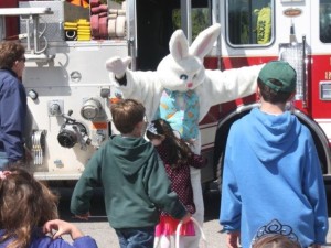 Easter Bunny arrives on fire truck, Easter, Happy Easter, child hugs Bunny, firefighers