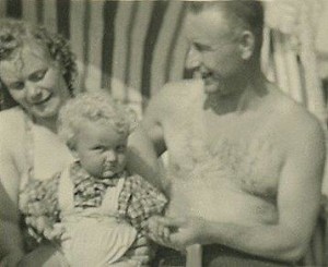 Family time at the beach, happy family, parents dote on little child, sweet family