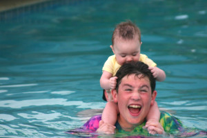Caribbean, sister in pool with brother, playing in pool, baby with brother, sweetness